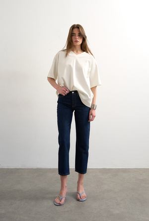 Front image of a model wearing the Runway cropped jeans in dark denim, by brand Top shop