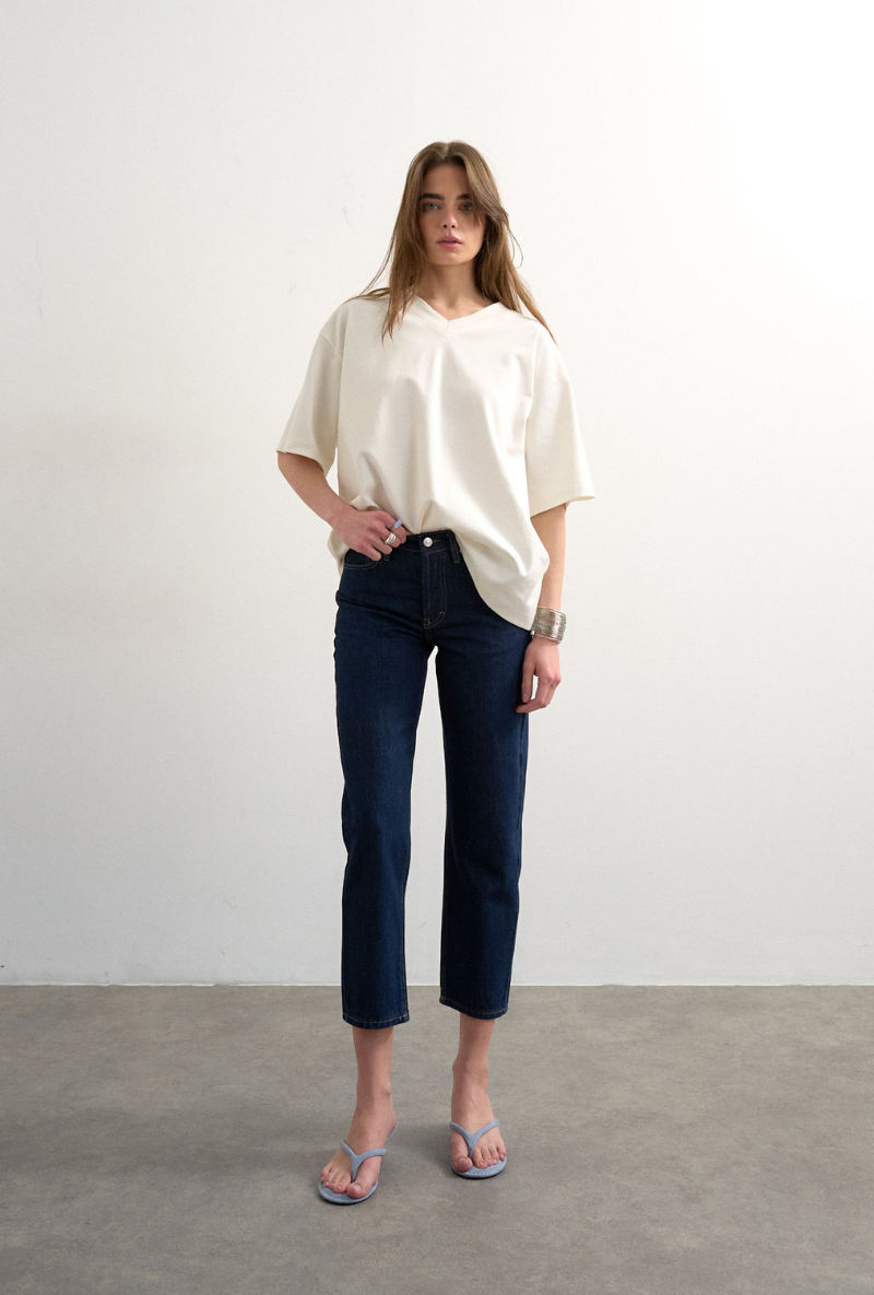 Front image of a model wearing Runway cropped jeans in dark denim, by brand Top shop