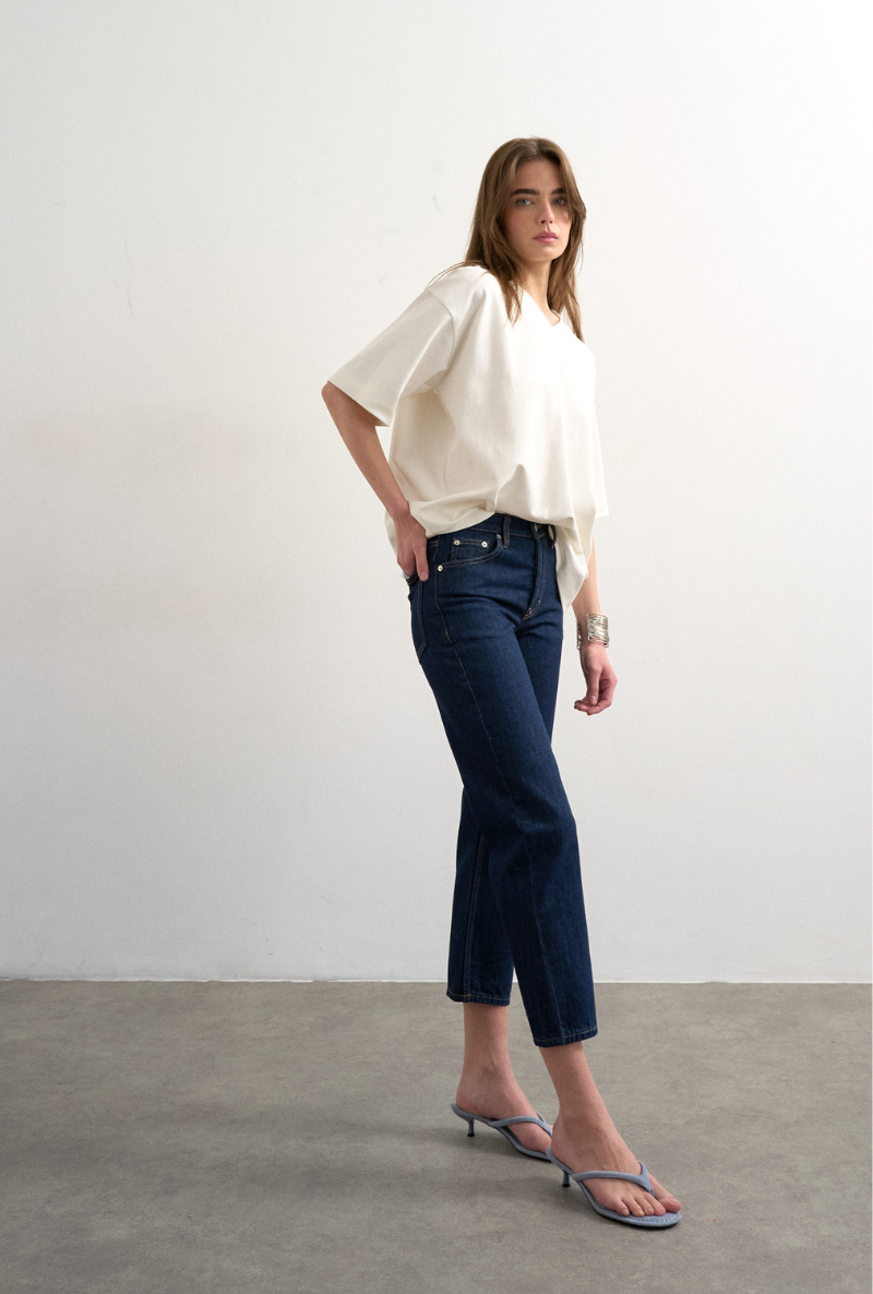 Front image of a model wearing Runway cropped jeans in dark denim, by brand Top shop