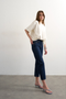 Front image of a model wearing the Runway cropped jeans in dark denim, by brand Top shop