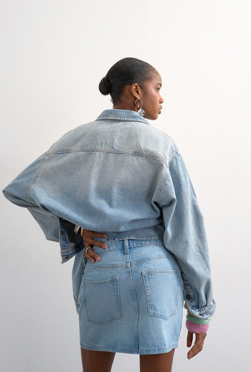 Back image of a model wearing Silje mini denim skirt in denim, by brand Top shop