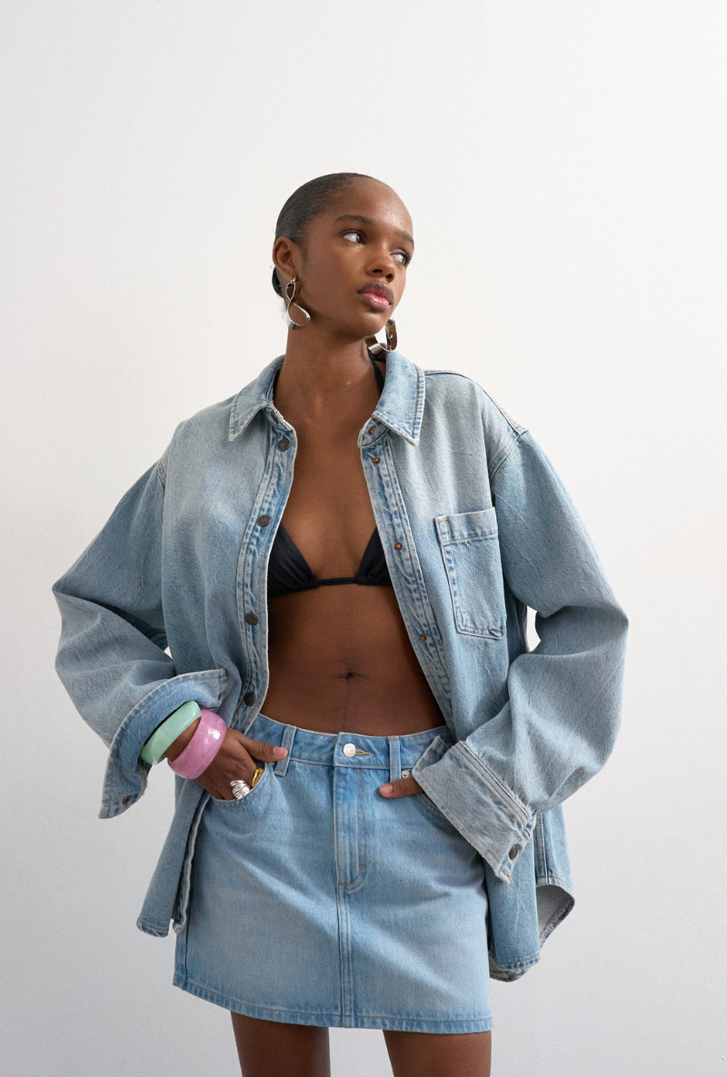 Front image of a model wearing Silje mini denim skirt in denim, by brand Top shop