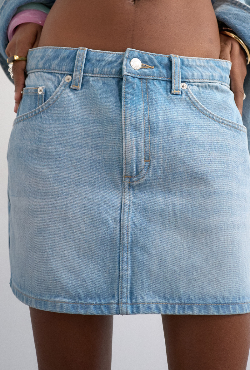 Front detail image of a model wearing Silje mini denim skirt in denim, by brand Top shop