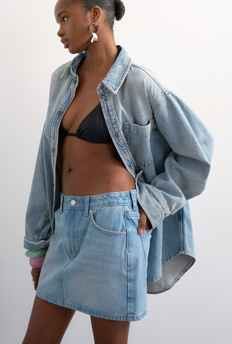 Front image of a model wearing Silje mini denim skirt in denim, by brand Top shop