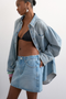 Front image of a model wearing the Silje mini denim skirt in denim, by brand Top shop