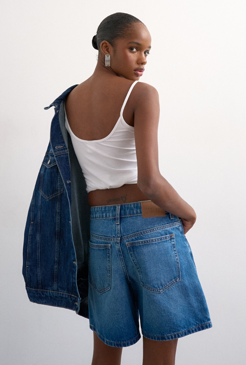Back image of a model wearing Vigga denim shorts in denim, by brand Top shop