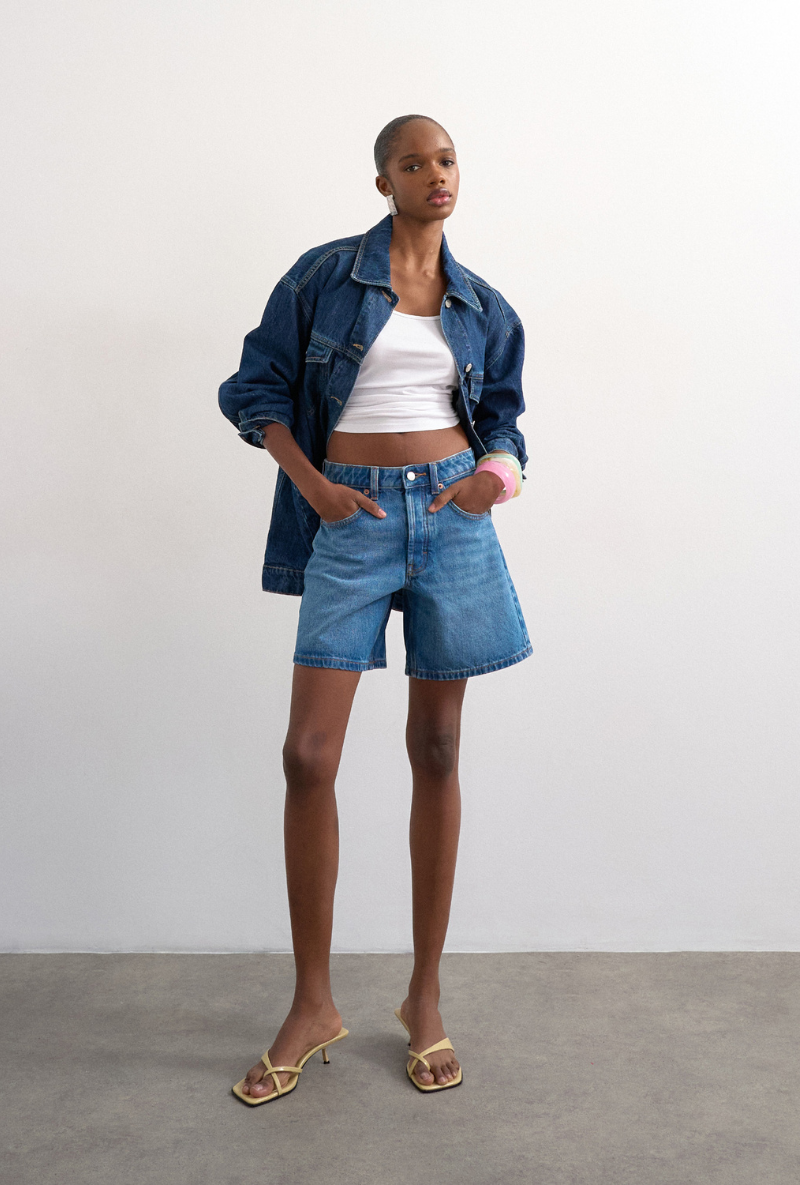 Front image of a model wearing Vigga denim shorts in denim, by brand Top shop