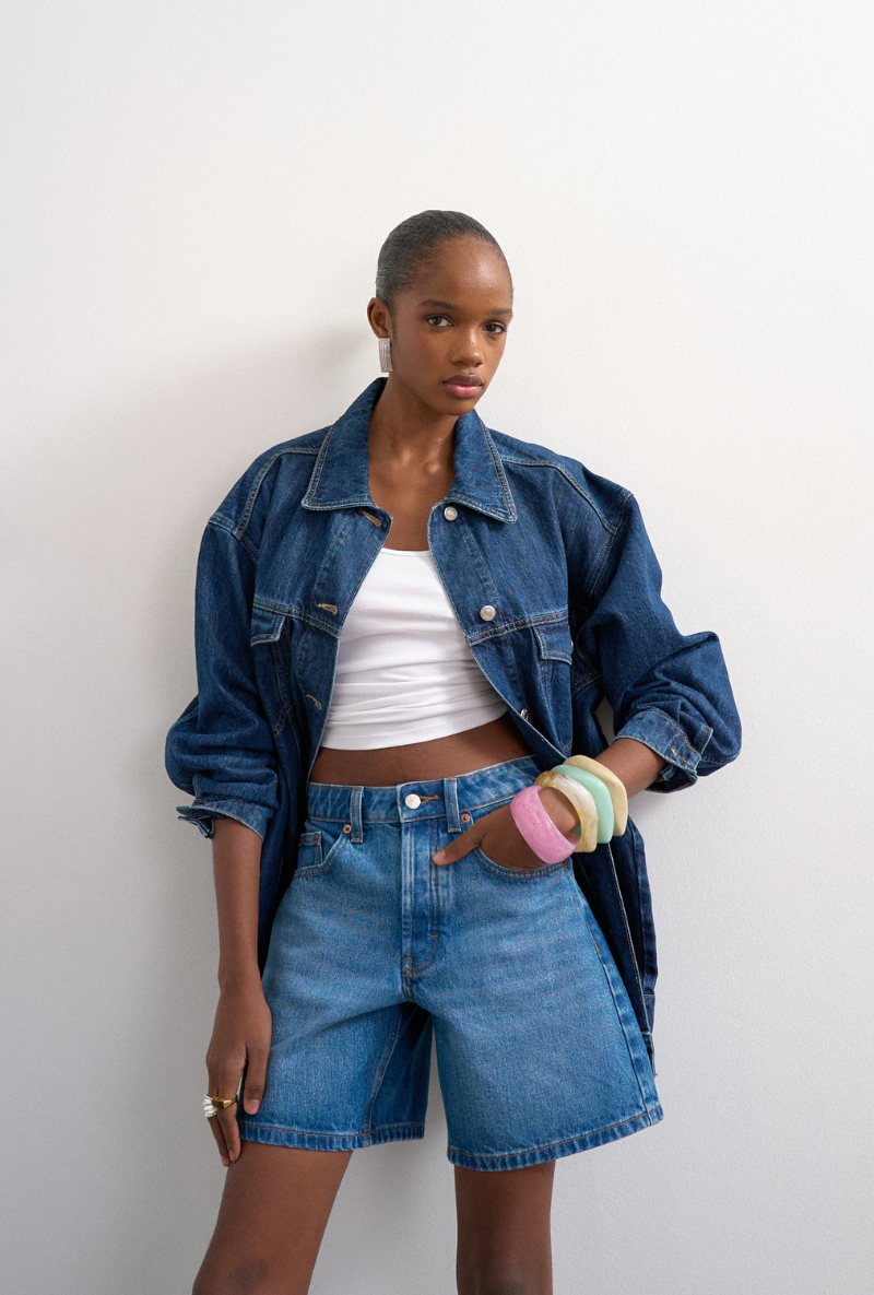 Front image of a model wearing Vigga denim shorts in denim, by brand Top shop