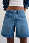 Front detail image of a model wearing the Vigga denim shorts in denim, by brand Top shop