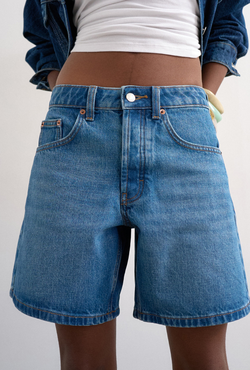 Front detail image of a model wearing Vigga denim shorts in denim, by brand Top shop