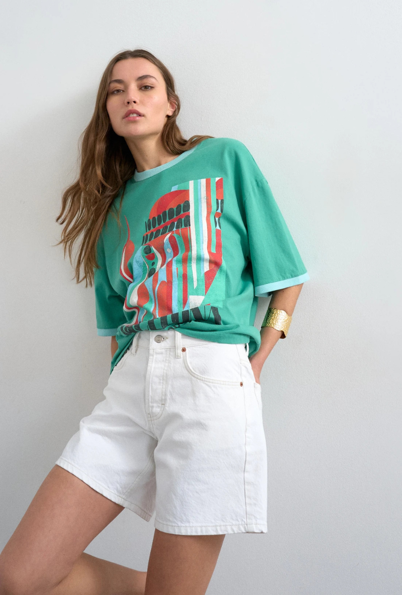 Front image of a model wearing Vigga high rise white denim shorts in white, by brand Top shop