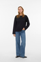 Front image of a model wearing Vero moda hali l/s boat neck top in black, by brand Vero moda
