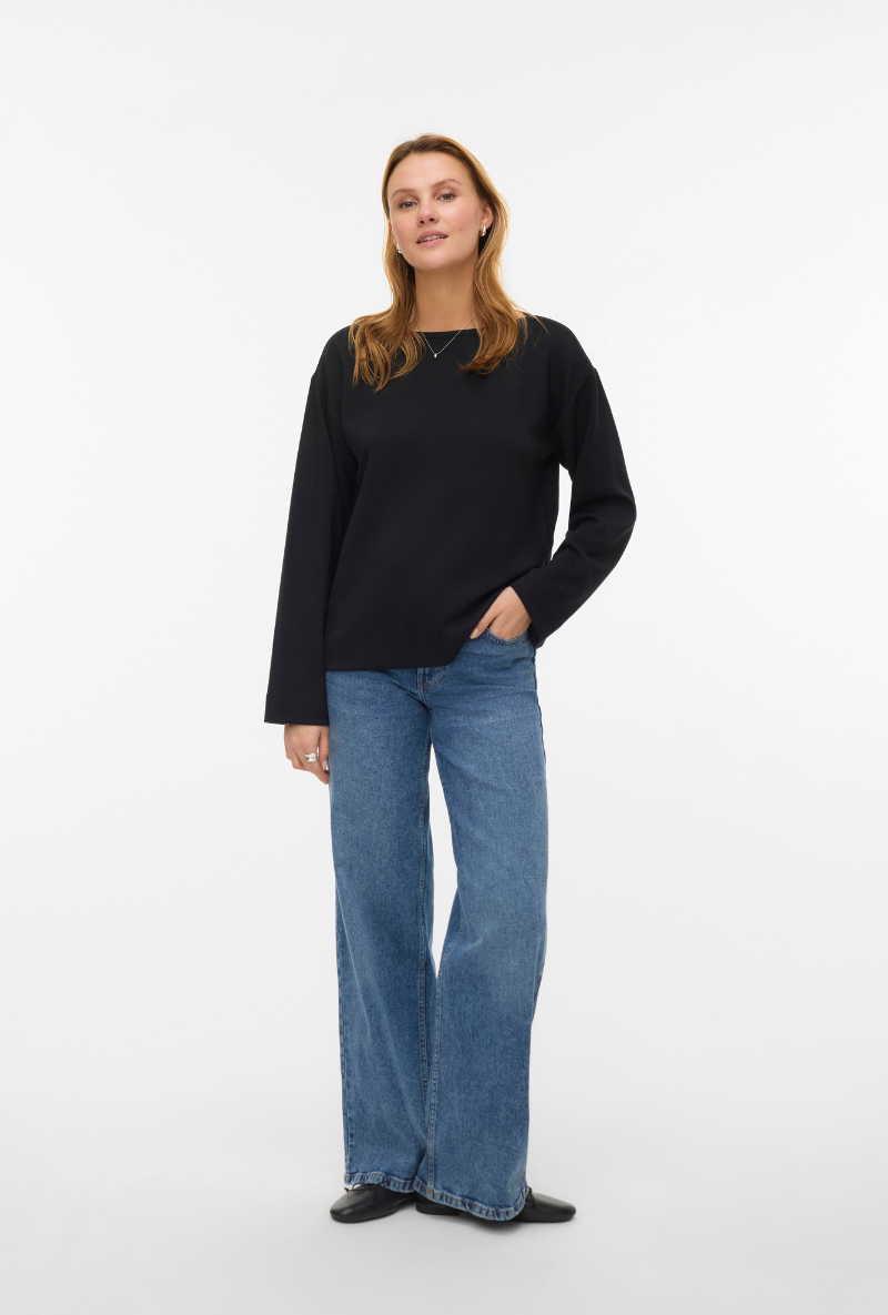 Front image of a model wearing Vero moda hali l/s boat neck top in black, by brand Vero moda