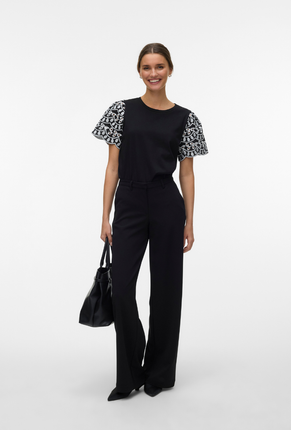 Front image of a model wearing Jasy o neck top in black, by brand Vero moda
