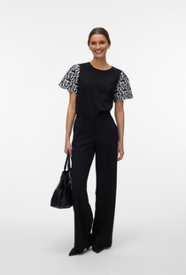 Front image of a model wearing the Jasy o neck top in black, by brand Vero moda