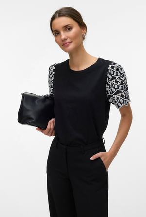 Front image of a model wearing the Jasy o neck top in black, by brand Vero moda