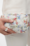 Front detail image of a model wearing Joy toilet bag in flower, by brand Vero moda