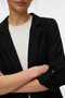 Front detail image of a model wearing the Milo loose blazer in black, by brand Vero moda