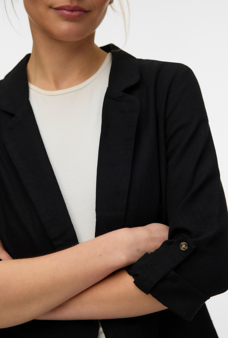 Front detail image of a model wearing Milo loose blazer in black, by brand Vero moda