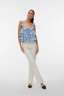 Front image of a model wearing the Sandy layered top in blue, by brand Vero moda