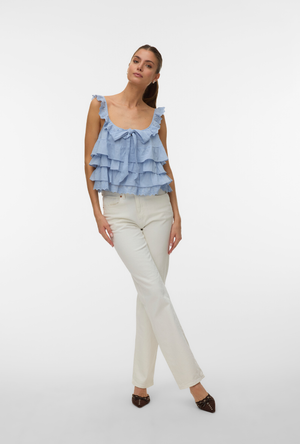 Front image of a model wearing the Sandy layered top in blue, by brand Vero moda