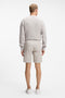 Back image of a model wearing the Chino slim shorts in light grey, by brand Boss