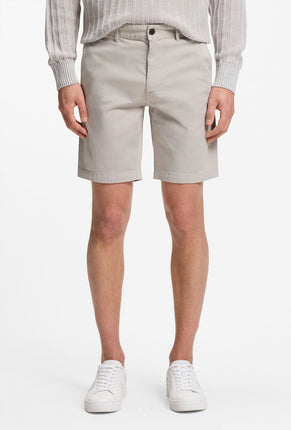 Front image of a model wearing Chino slim shorts in light grey, by brand Boss
