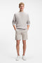 Front image of a model wearing the Chino slim shorts in light grey, by brand Boss