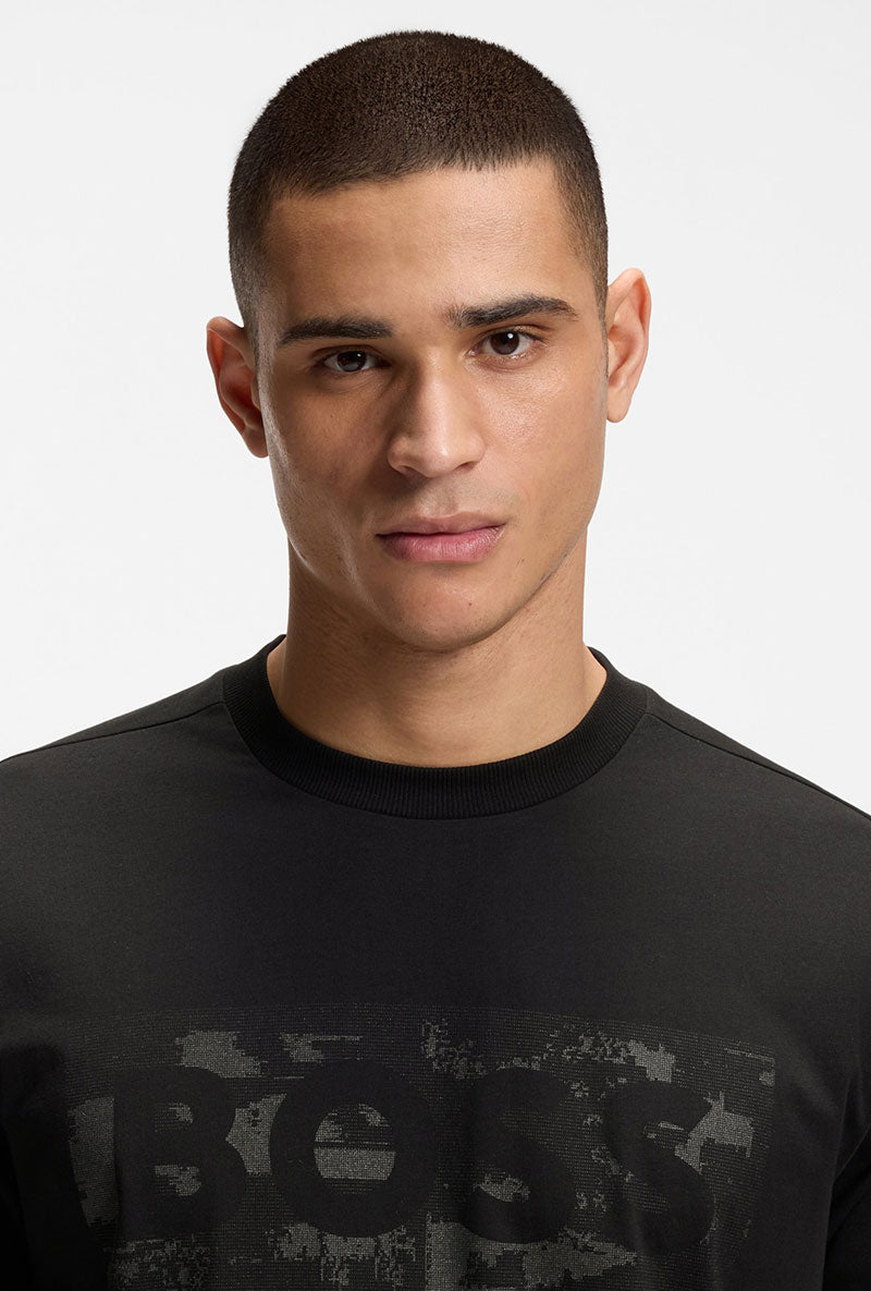 Front image of a model wearing Globe logo tshirt in black, by brand Boss