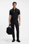 Front image of a model wearing the Philix zip polo in black, by brand Boss