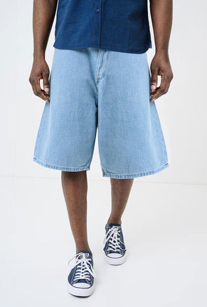 Front image of a model wearing Mason bermuda shorts in denim, by brand Hugo