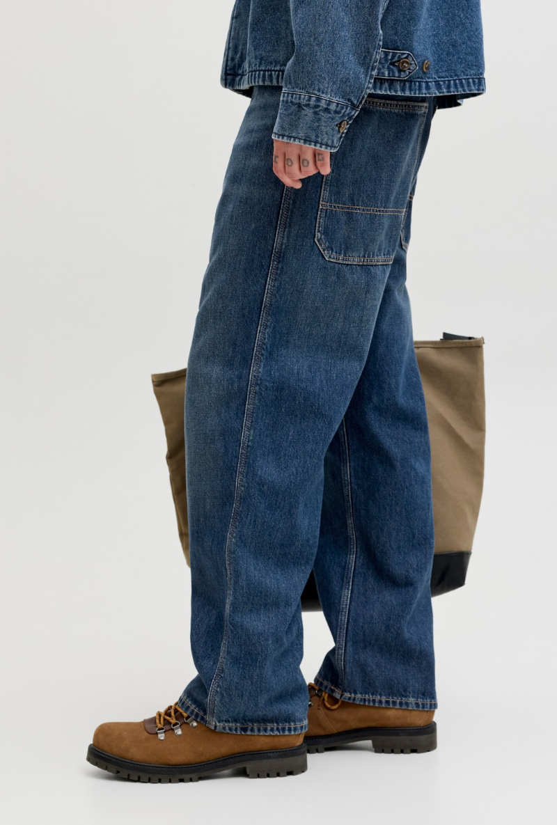 Side image of a model wearing Jack and jones alex norrebro jeans in denim, by brand Jack&jones