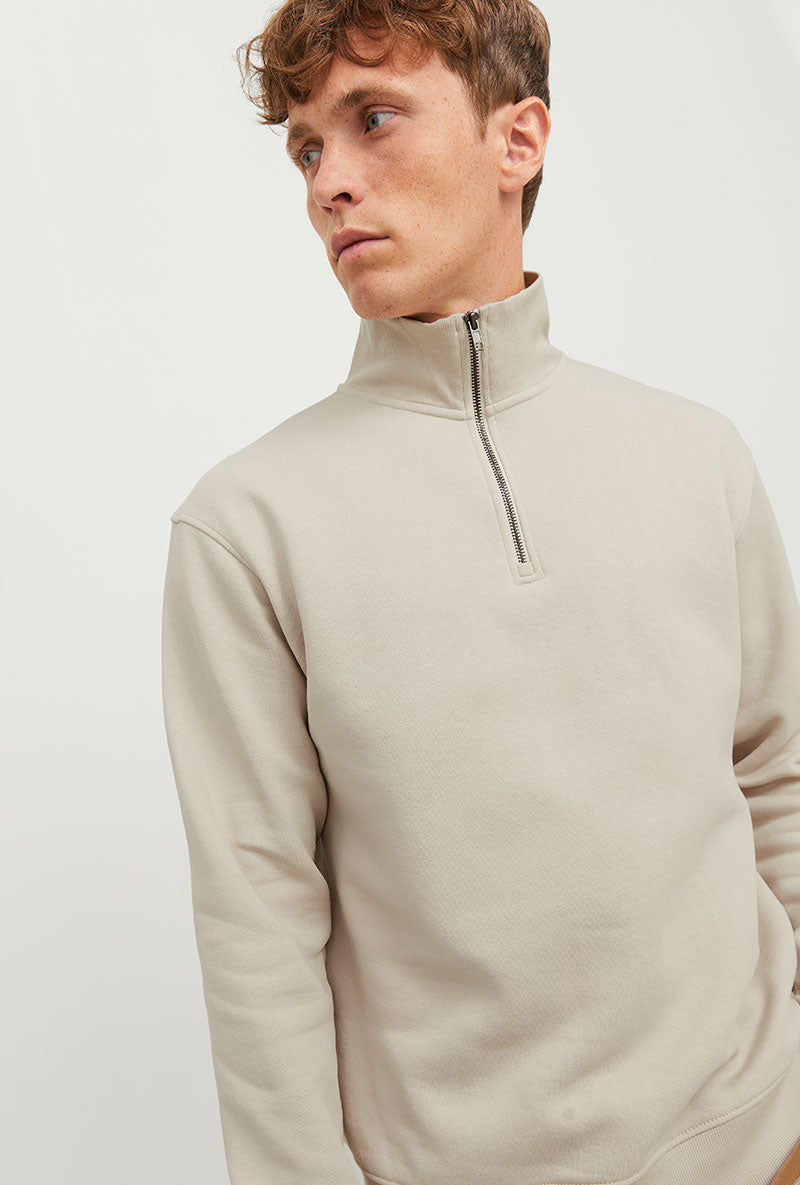 Front image of a model wearing Bradley sweat half zip sweatshirt in beige, by brand Jack&jones