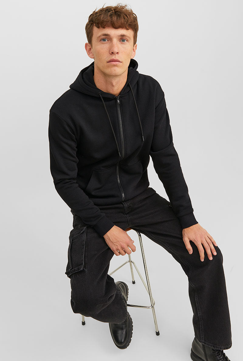 Front image of a model wearing Bradley sweat zip hood in black, by brand Jack&jones