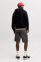 Back image of a model wearing the Cole matty cargo shorts in charcoal, by brand Jack&jones