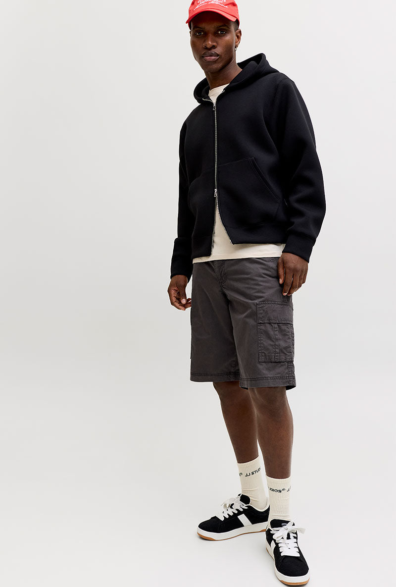Front image of a model wearing Cole matty cargo shorts in charcoal, by brand Jack&jones