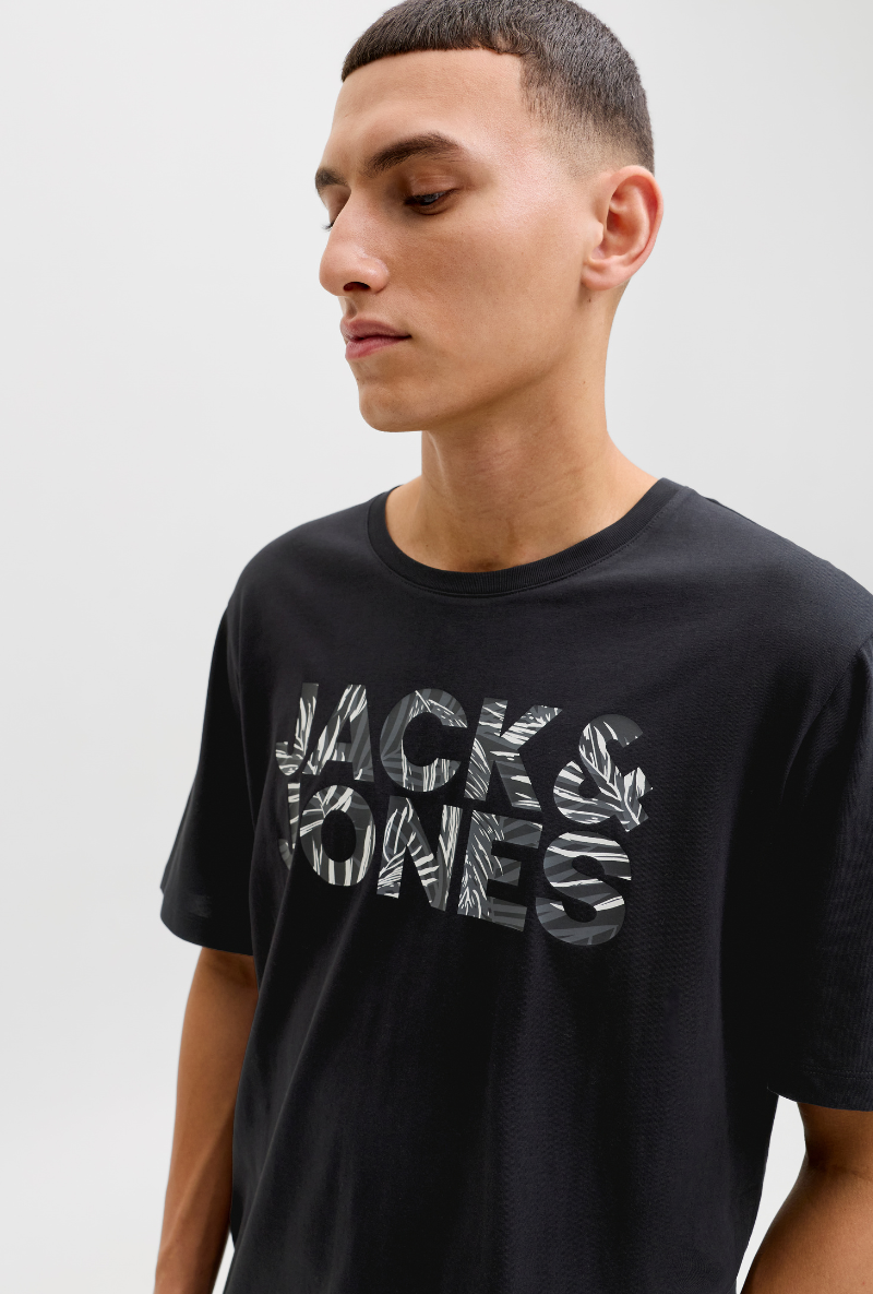 Front image of a model wearing Jack and jones jeff logo tee in black, by brand Jack&jones