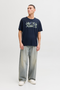 Front image of a model wearing Jack and jones jeff logo tee in navy, by brand Jack&jones
