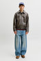 Front image of a model wearing the Marlon pu jacket in brown, by brand Jack&jones