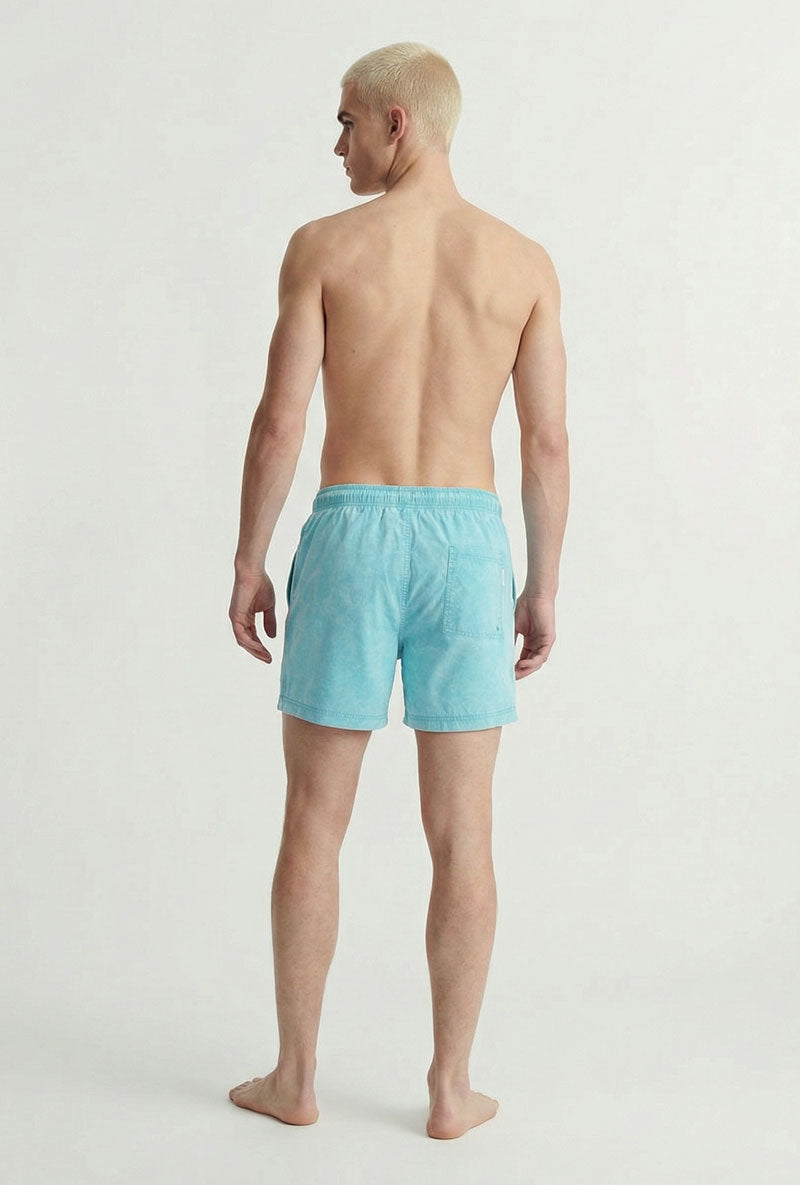 Back image of a model wearing Maui vibrant wash swimshorts in blue, by brand Jack&jones