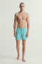 Front image of a model wearing the Maui vibrant wash swimshorts in blue, by brand Jack&jones