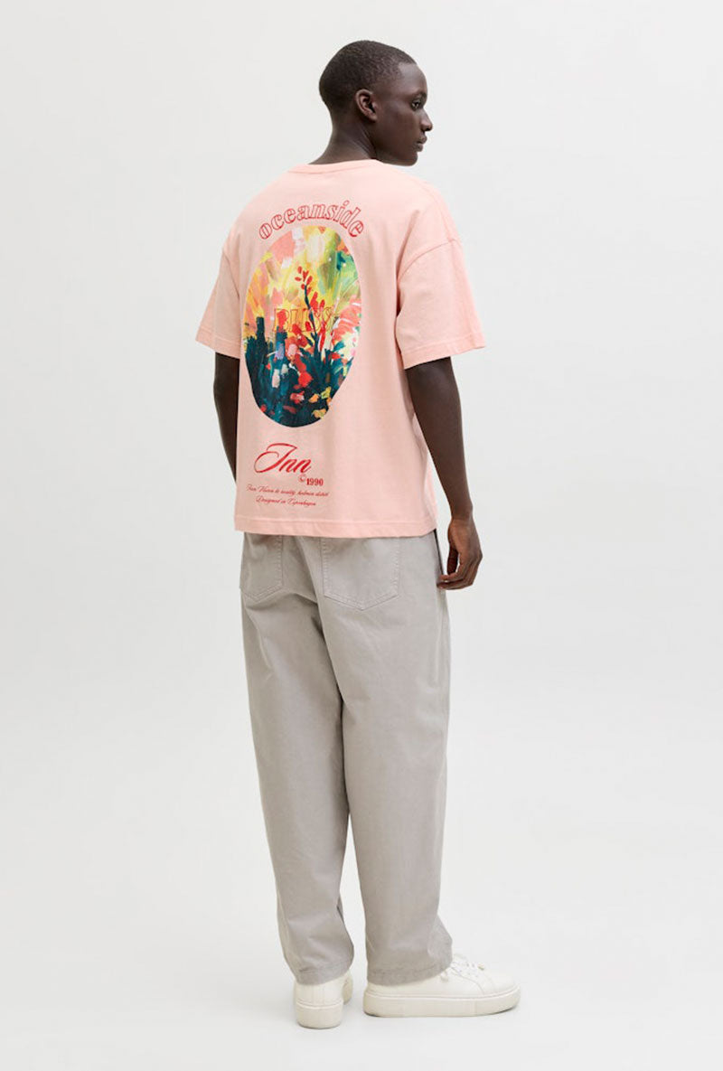 Back image of a model wearing Montauk back graphic tee in peach, by brand Jack&jones