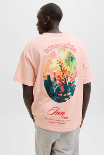 Back image of a model wearing the Montauk back graphic tee in peach, by brand Jack&jones