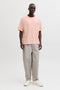Front image of a model wearing the Montauk back graphic tee in peach, by brand Jack&jones