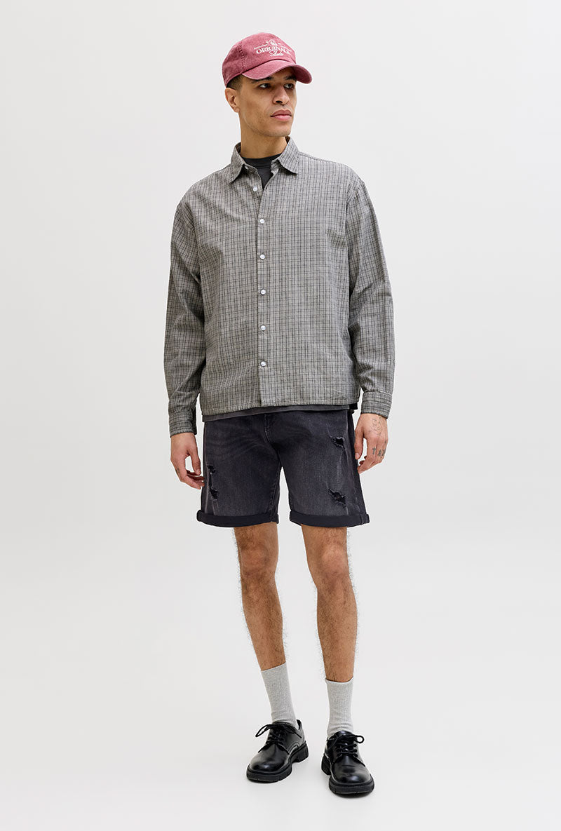Front image of a model wearing Rick jj fox denim shorts in black, by brand Jack&jones