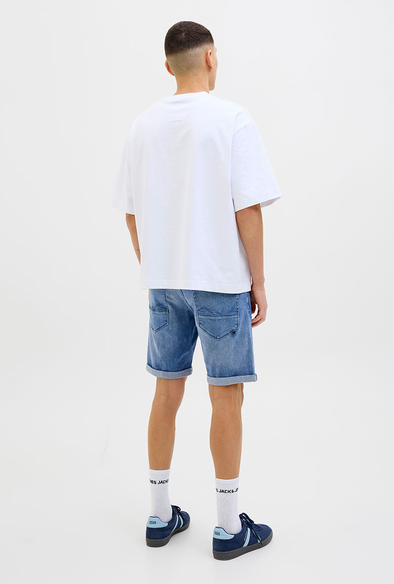 Back image of a model wearing Rick jj fox denim shorts in light denim, by brand Jack&jones