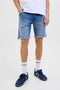 Front image of a model wearing Rick jj fox denim shorts in light denim, by brand Jack&jones