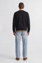 Back image of a model wearing the Rush sweat crew neck sweatshirt in black, by brand Jack&jones