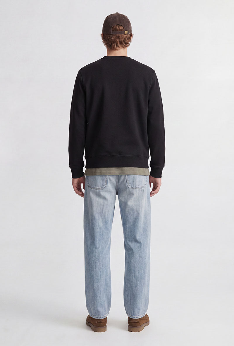 Back image of a model wearing Rush sweat crew neck sweatshirt in black, by brand Jack&jones