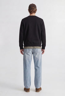 Back image of a model wearing the Rush sweat crew neck sweatshirt in black, by brand Jack&jones